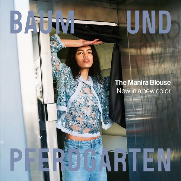 This ad showcases Baum Und Pferdgarten's new color for The Manira Blouse, presenting the product in an indoor, styli