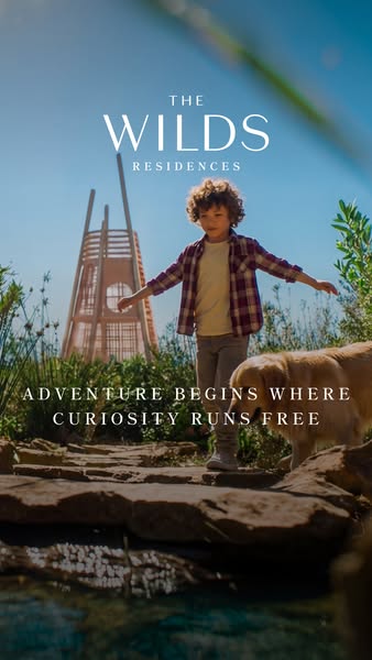 This ad uses an image of a child walking with a dog to promote The Wilds Residences. The image is shot from a low angle 