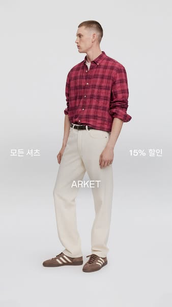 The ad showcases a male model wearing a pink and black plaid shirt, light-colored jeans, and brown Adidas sneakers, adve