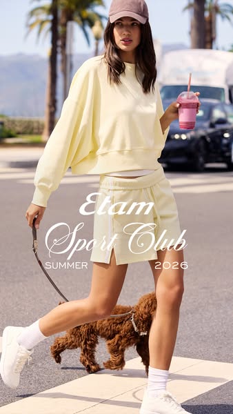 This ad for Etam Sport Club features a model walking outside with her dog, wearing a matching pale yellow sweatshirt and