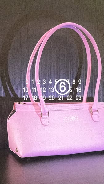Image ad showcasing a pink handbag with a calendar graphic suggesting an upcoming date.