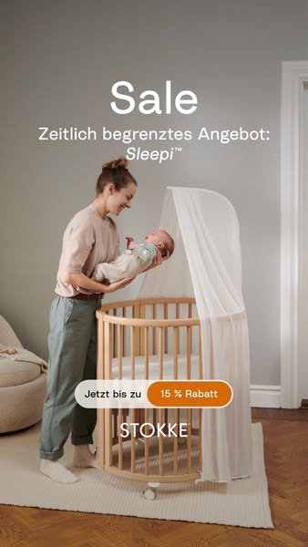This ad for Stokke features a light wood colored bassinet with white, sheer fabric and shows a woman holding a baby abov