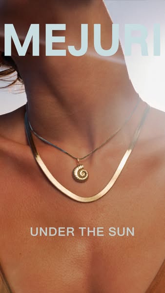 This image ad promotes Mejuri jewelry, specifically two gold necklaces worn by a model in an outdoor, sunlit setting. Th