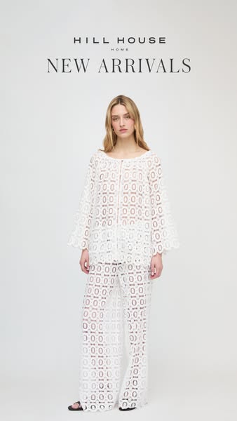 This image ad showcases the new arrivals from Hill House Home, featuring a model wearing a white lace top and matching p