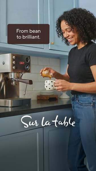 This Meta ad features an image of an espresso machine in a kitchen setting, highlighting the brand Sur la table. A woman