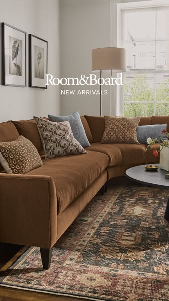 An image ad showcasing Room & Board's new furniture arrivals. The ad features a stylishly arranged living room s