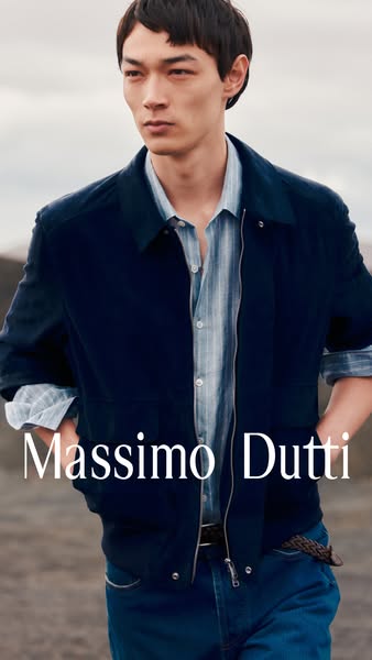This image ad features a male model wearing Massimo Dutti apparel. The setting is an outdoor landscape with a neutral co