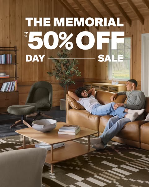 This ad promotes a Memorial Day sale for a home goods retailer. It features a cozy living room setting with a couple rel