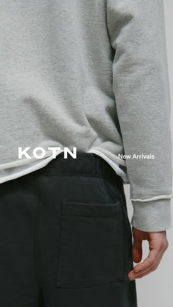 This image ad features new arrivals from KOTN. The ad is a close-up shot of a person wearing a grey sweatshirt and black