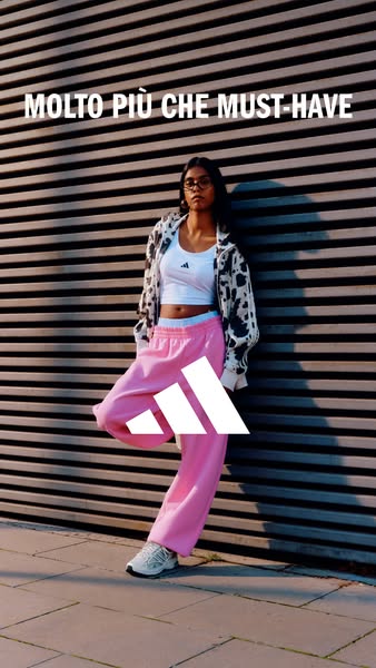 This ad for Adidas features a young woman leaning against a horizontally-striped wall. She is wearing Adidas apparel. Th