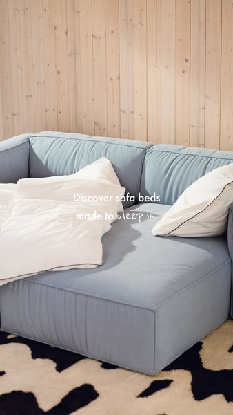 This ad shows a blue sofa bed. The text overlay indicates that it is 'made to sleep in'.