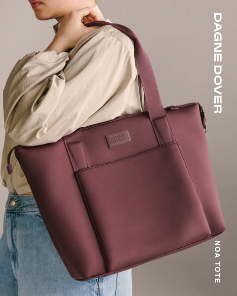 This ad showcases a Dagne Dover tote bag. It highlights the sleek and stylish design of the tote in a solid plum color.