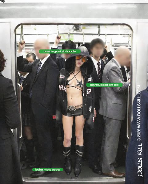 This image ad showcases a person standing in a crowded subway car wearing a selection of Dollskill's clothing: A stu