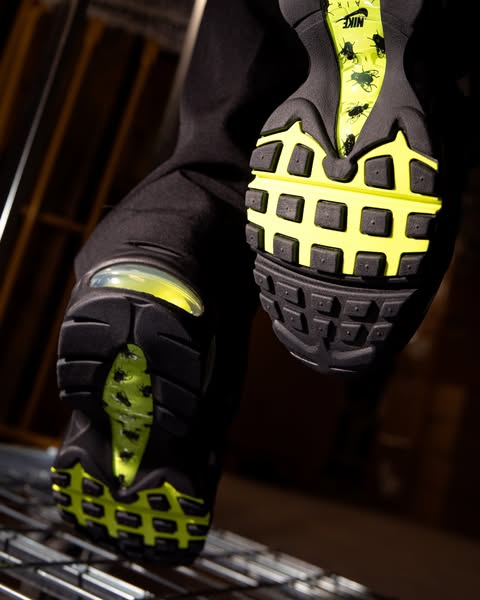 A close up shot of the bottom of a shoe with a fly pattern on the sole.