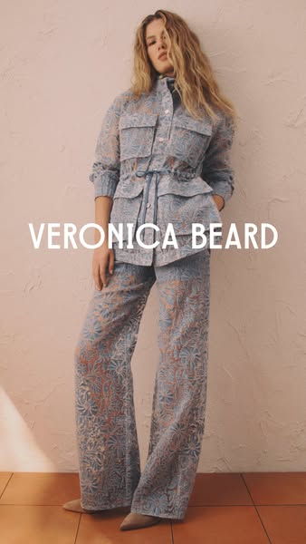 This ad features a woman in a Veronica Beard outfit posing against a textured wall. The ad highlights the brand name in 