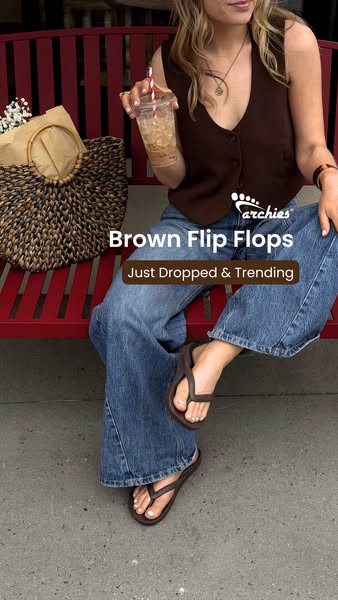 The ad showcases a pair of brown flip flops in a lifestyle setting, emphasizing their trendy appeal. A woman is sitting 