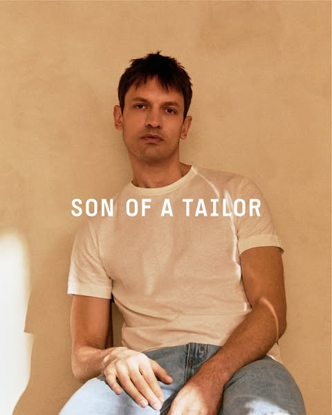 This is a product ad showcasing Son of a Tailor brand apparel. The photo features a man in a Son of a Tailor t-shirt and