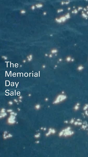 The ad is promoting a Memorial Day Sale. The image shows a background of blue water with glimmers of reflected light.