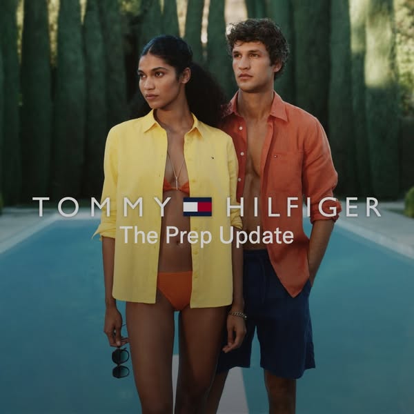 This image ad for Tommy Hilfiger features two models in swimwear and unbuttoned shirts, standing in front of a pool and 