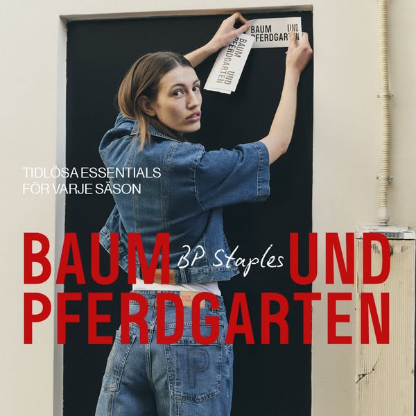 This ad features a woman hanging up branded promotional materials against a dark door, overlaid with brand messaging. Th