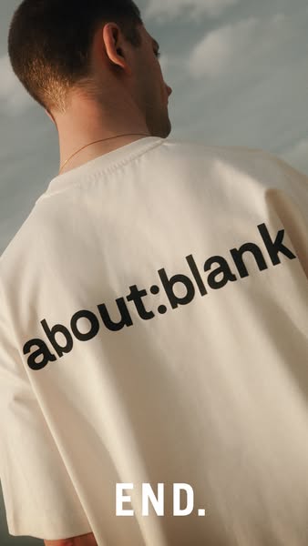This image ad features a man wearing a cream-colored t-shirt with the brand name printed on the back, intended to showca