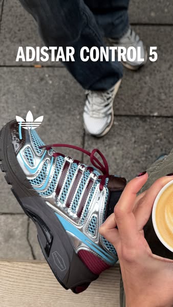 This ad showcases the Adidas Adistar Control 5 shoe. The ad features a lifestyle image of the shoe, a coffee, and other 