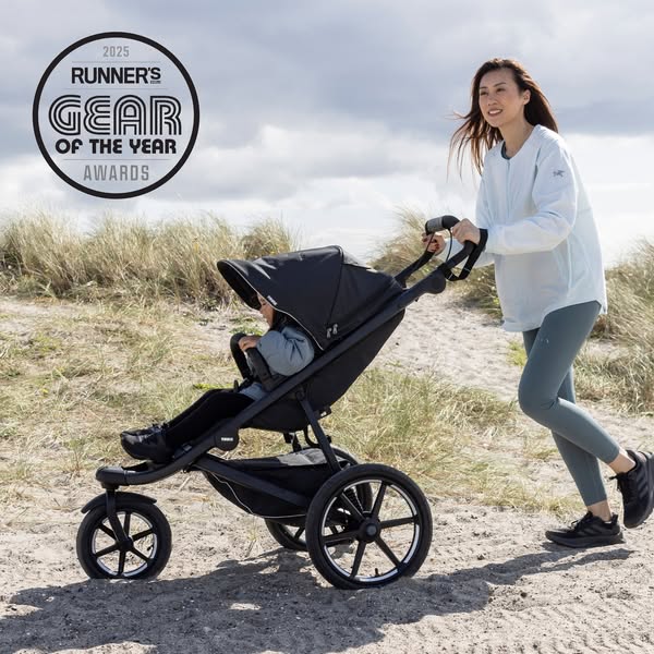 This ad features a woman pushing a stroller along a beachside path, highlighting the 'Runner's Gear of the Year&