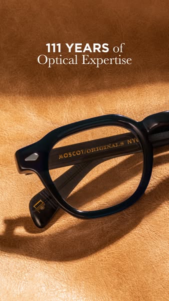 This image ad for Moscot Eyewear features a close up studio shot of a pair of sunglasses against a brown leather backgro