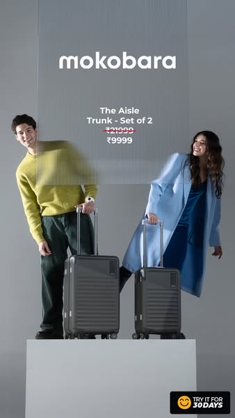 This ad features a set of 2 Mokobara Aisle Trunk suitcases, presented by two people who are standing behind a semi-trans