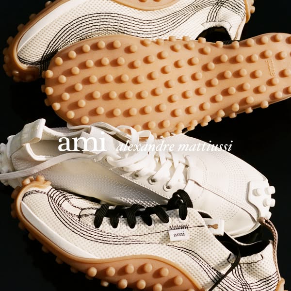 This ad features a high-fashion sneaker by AMI Alexandre Mattiussi, highlighting its design and construction.