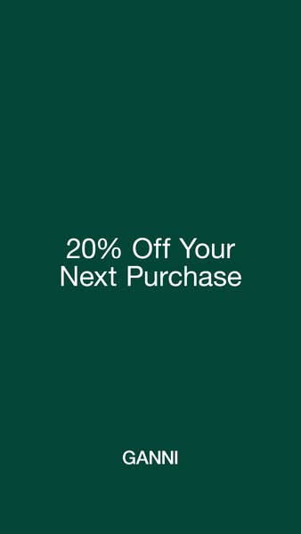 This ad for GANNI features a simple design with a solid green background and white text promoting a 20% discount on the 