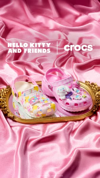 This image ad features two Crocs clogs from the Crocs x Hello Kitty and Friends collaboration. The clogs are displayed o