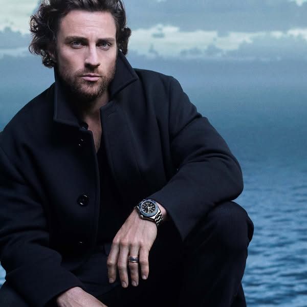 This ad features a man wearing a watch while crouching near the ocean. The ad focuses on the watch and the man's sty