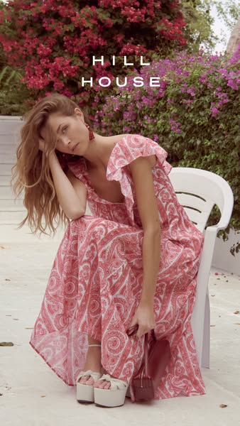 An image ad for Hill House Home features a woman wearing a pink and white dress, with a blooming flower bush in the back