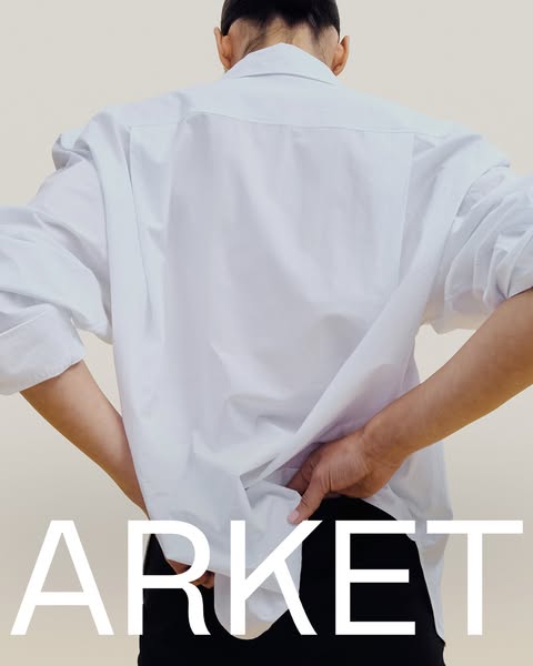 This ad from ARKET showcases a white button-down shirt with the brand name in large white letters.