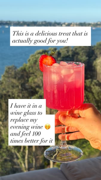 The ad shows a hand holding a wine glass filled with a pink drink over an outdoor backdrop. The text describes it as a t