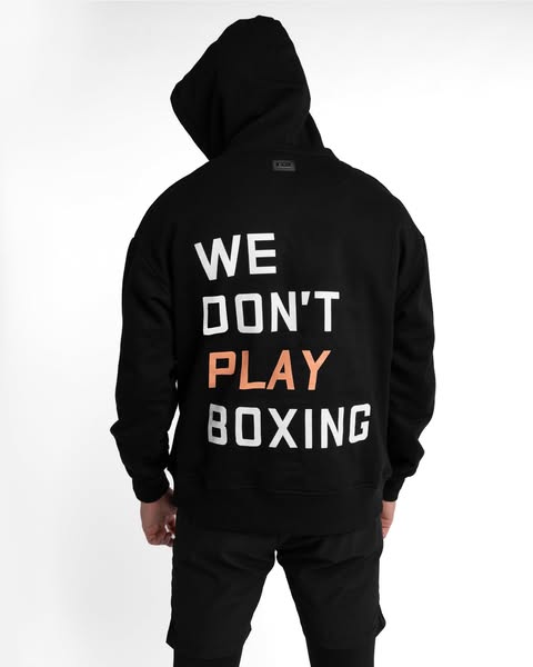 This ad features a person wearing a black hoodie and pants. The back of the hoodie has the text 'WE DON'T PLAY B