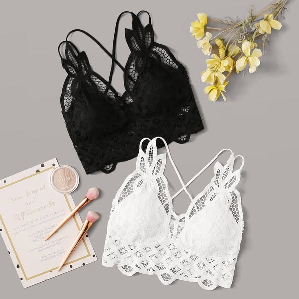 This image ad features a flatlay of two lace bralettes, a makeup compact, two makeup brushes, a wedding invitation, and 
