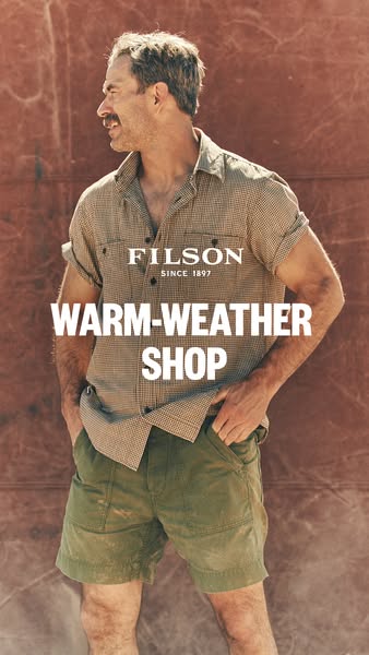 This ad features a man wearing Filson clothing, specifically a shirt and shorts, against a textured, earthy background. 