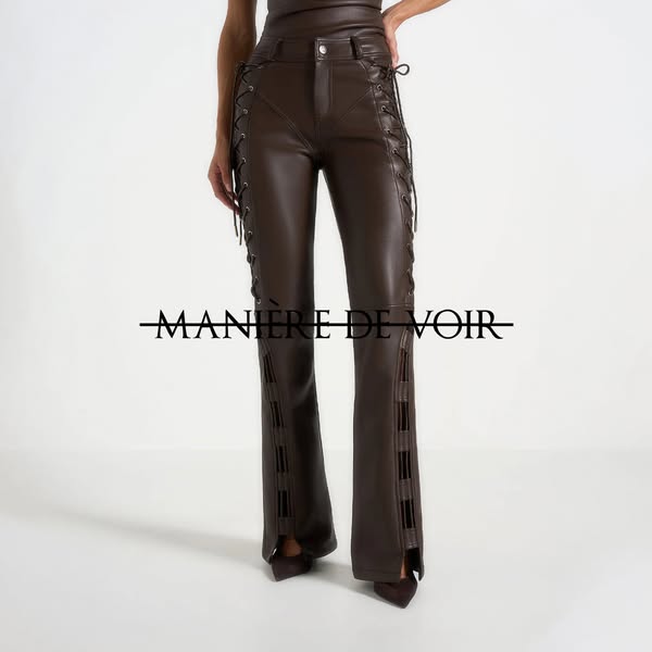 This image ad showcases a pair of dark brown leather pants. The pants have lace-up detailing on the sides and slit openi