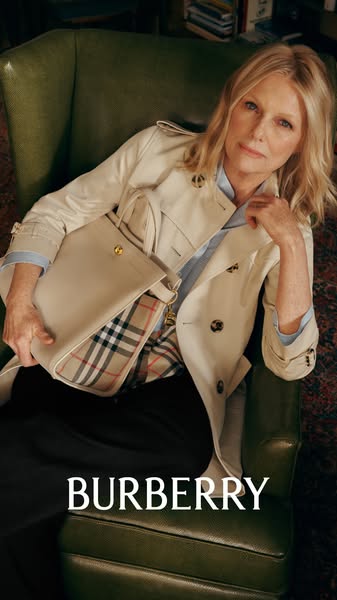 The ad features a luxury brand's handbag and apparel in an editorial style. It showcases the brand's classic aes
