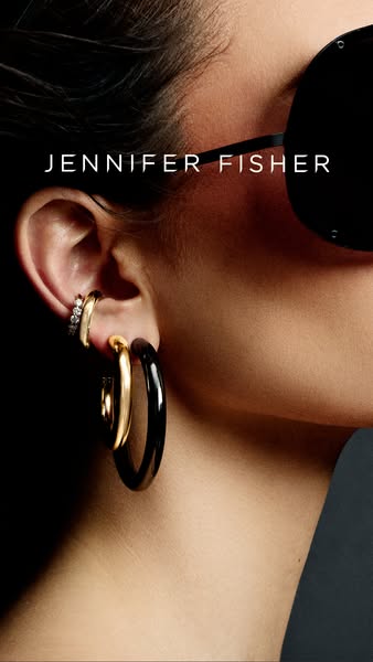 This Jennifer Fisher ad features a close-up shot of a model wearing earrings from the jewelry brand. The image and simpl
