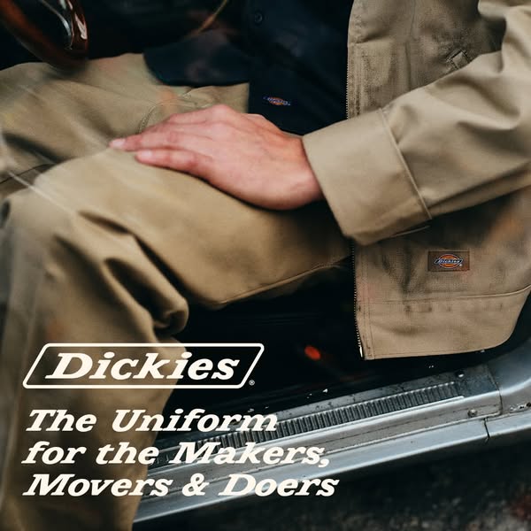 This image ad showcases Dickies apparel. A person is seen inside a car, wearing Dickies pants and a jacket. The ad promo