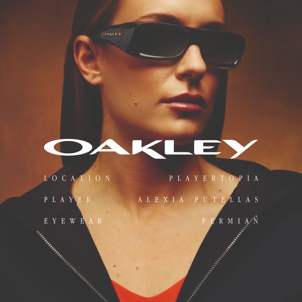 An image ad featuring a woman wearing Oakley sunglasses, focusing on the brand and eyewear model.