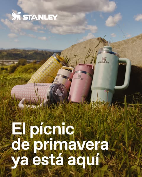 This image ad features a collection of Stanley thermoses and tumblers in an outdoor setting. The ad's main focus is 
