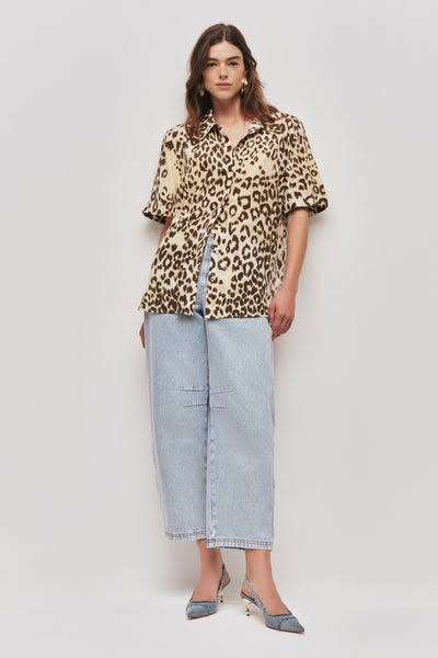 This ad features a woman modeling a leopard print shirt, light wash jeans, and heels. The ad is a simple product showcas