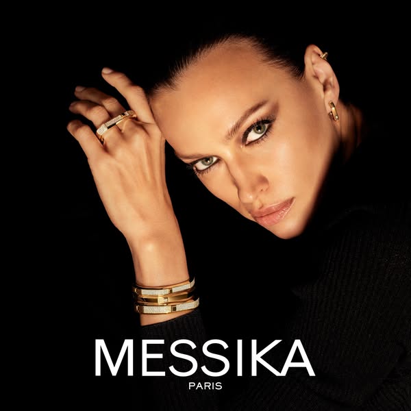 This ad features a close-up shot of a woman wearing multiple pieces of Messika jewelry, including a ring, bangle, and ea