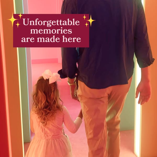 This image ad shows a back view of a man and a girl walking down a brightly lit, multicolored hallway. The words "U