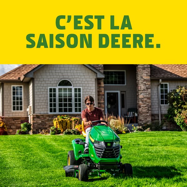An image ad features a man riding a John Deere lawn mower on a well-manicured lawn in front of a large house. The ad'