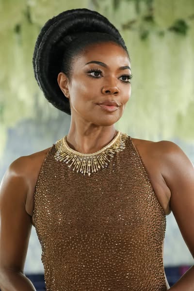 Close up shot of celebrity in a designer dress and jeweled necklace.